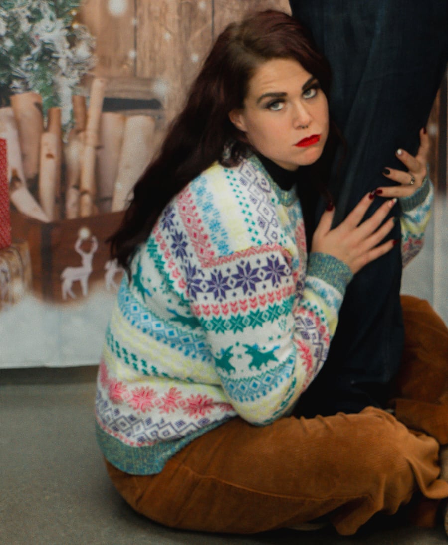 Bretta posing in a colorful holiday sweater